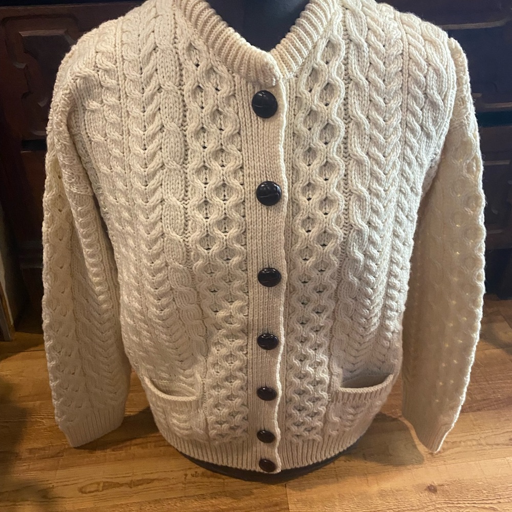 Aran Isles knitwear button up cardigan with front pockets. 100% merino wool.